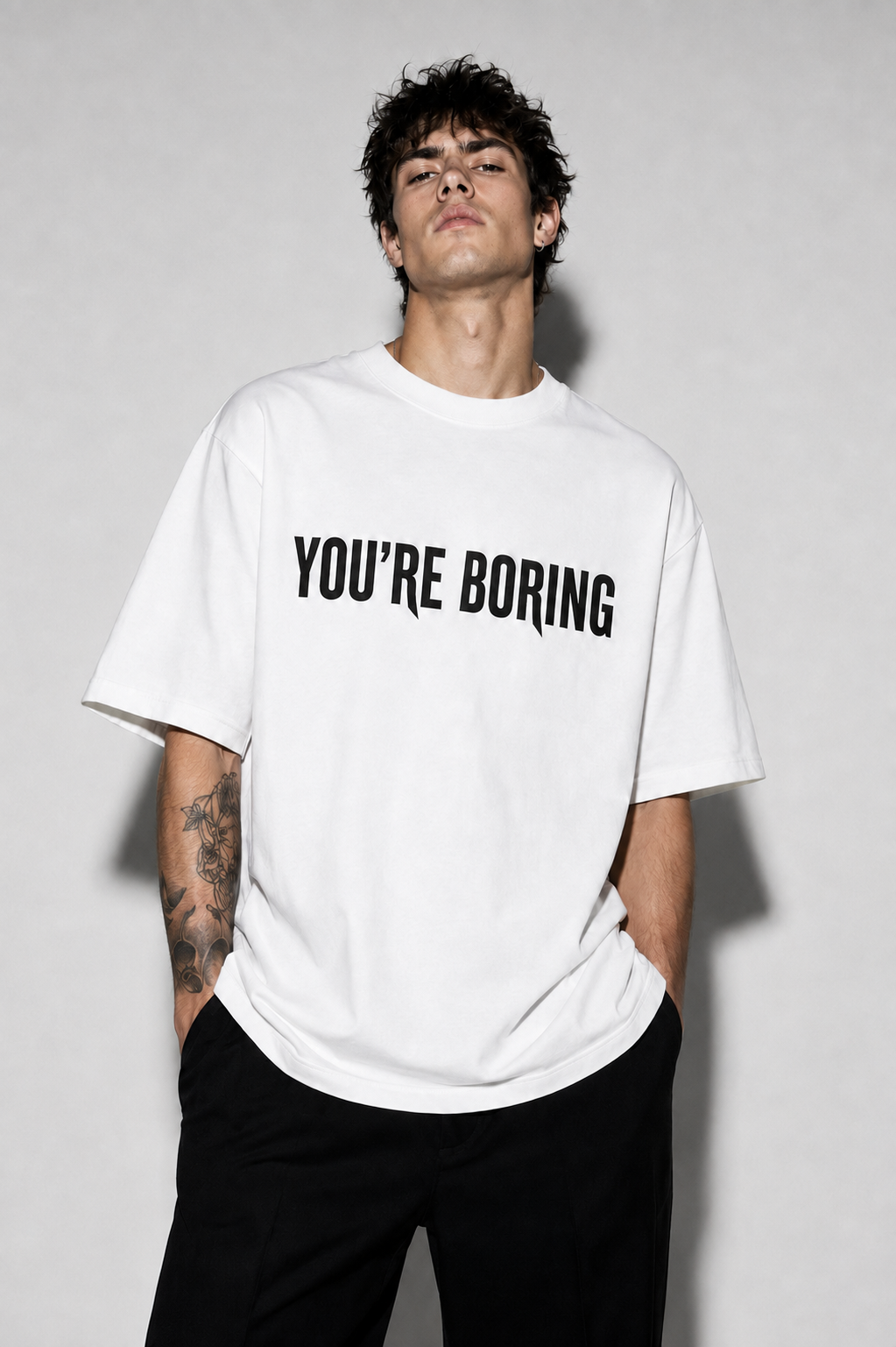 Male model wearing the oversized white You're Boring original T-shirt